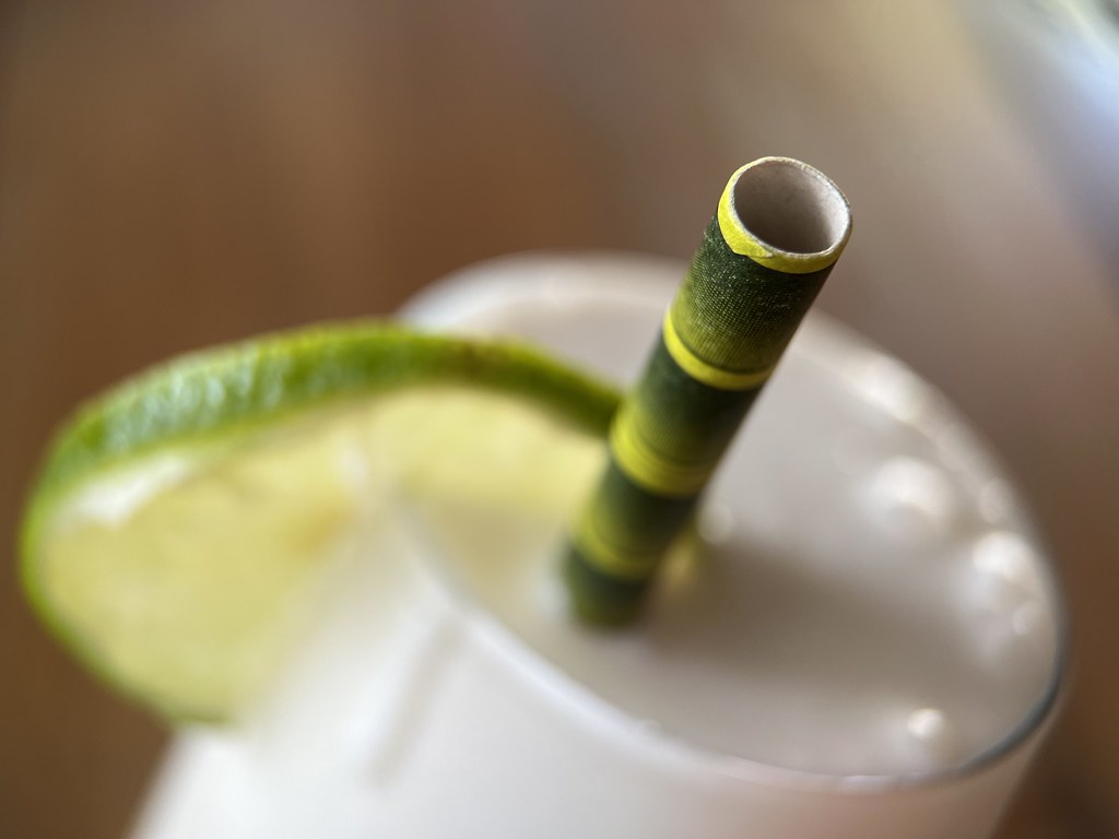 A paper straw in a drink as a wet-use application scene